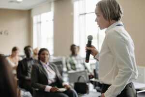 a businesswoman talking on a microphone